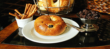 A cinnamon raisin bagel from Real New York Bagels.  Yes, this picture was taken on our coffee table in the living room with only natural light.  (2005)
