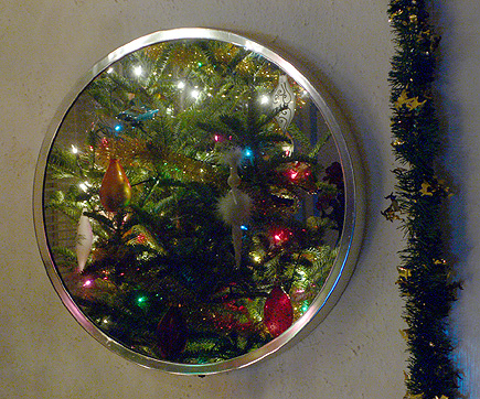 Our Christmas tree reflected in one of the living room mirrors.  Good Feng Shui, eh?  Oh, and Candy apologizes for the bald spot (it is the back of the tree after all).  (2005)