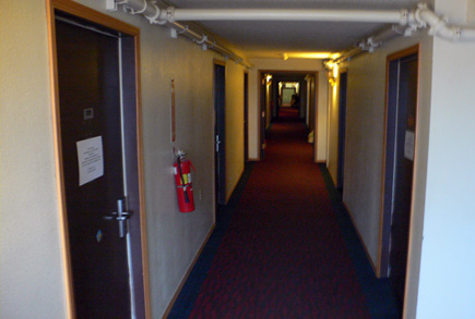 Hallway at the top of the stairs at the Top of the World hotel.  Our room (230) is the fifth door down on the left.  (2007)